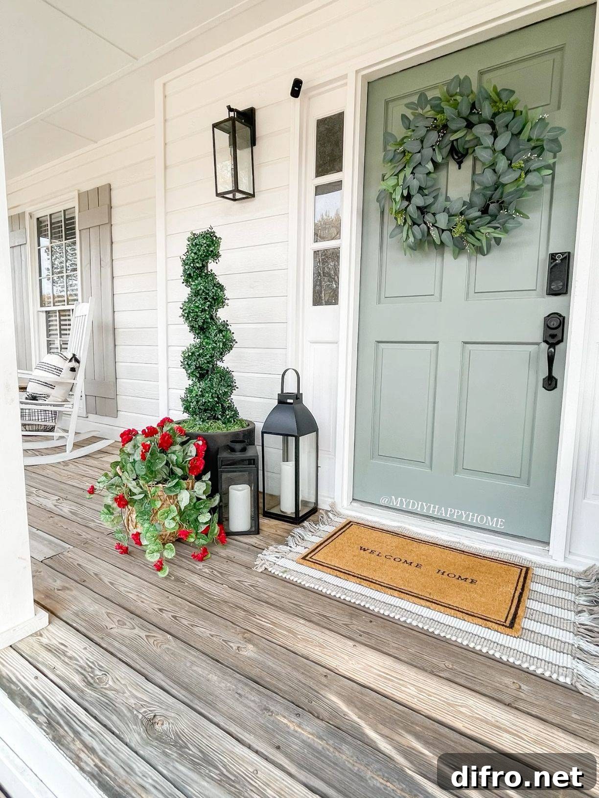 A sage green door with a wreath on it.