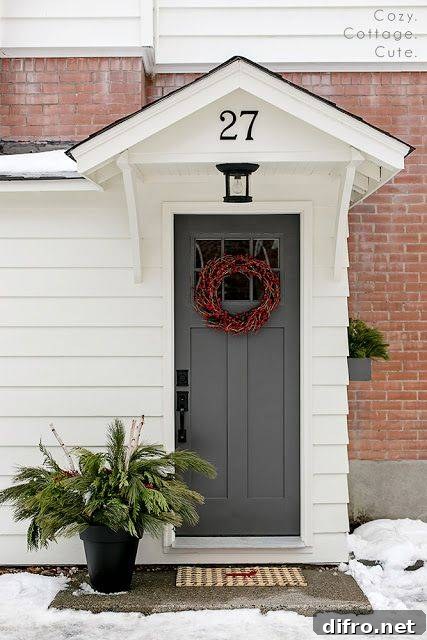 A grey door with a wreath on it.