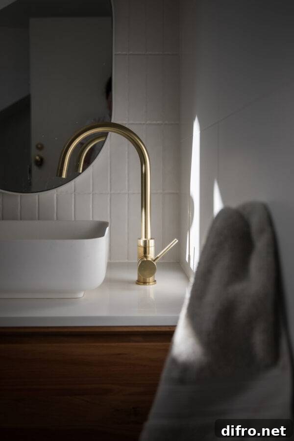 A bathroom sink, faucet, and mirror.