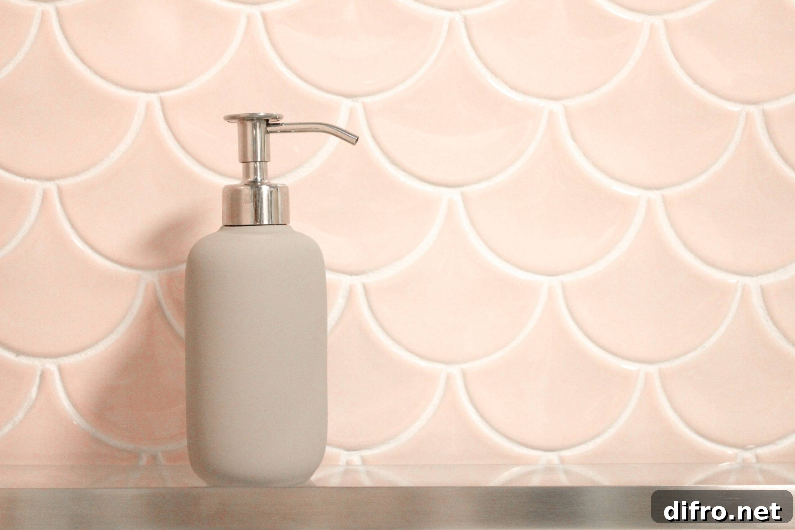 Scalloped tiles with a soap dispenser in front.