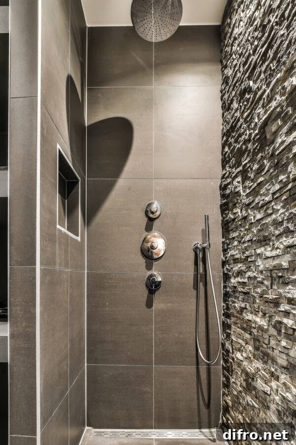 A dark shower with a stone feature wall.