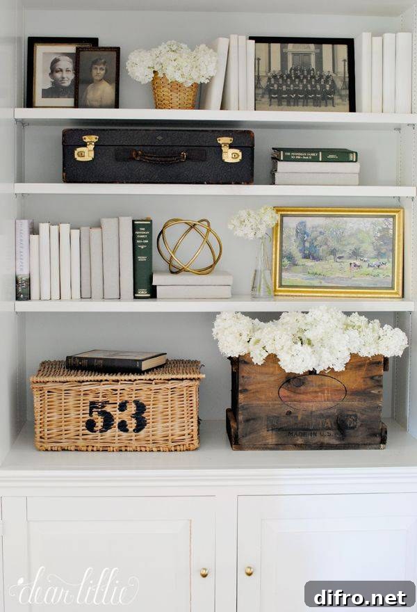 A nicely decorated bookcase with storage.