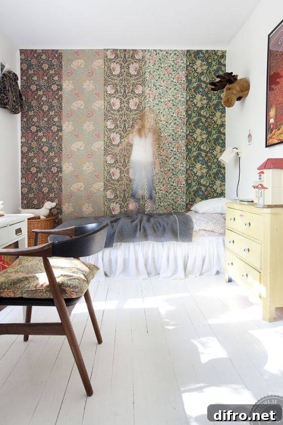 A bedroom with a feature wall of multiple wallpapers, a blurred little girl jumping on the bed.