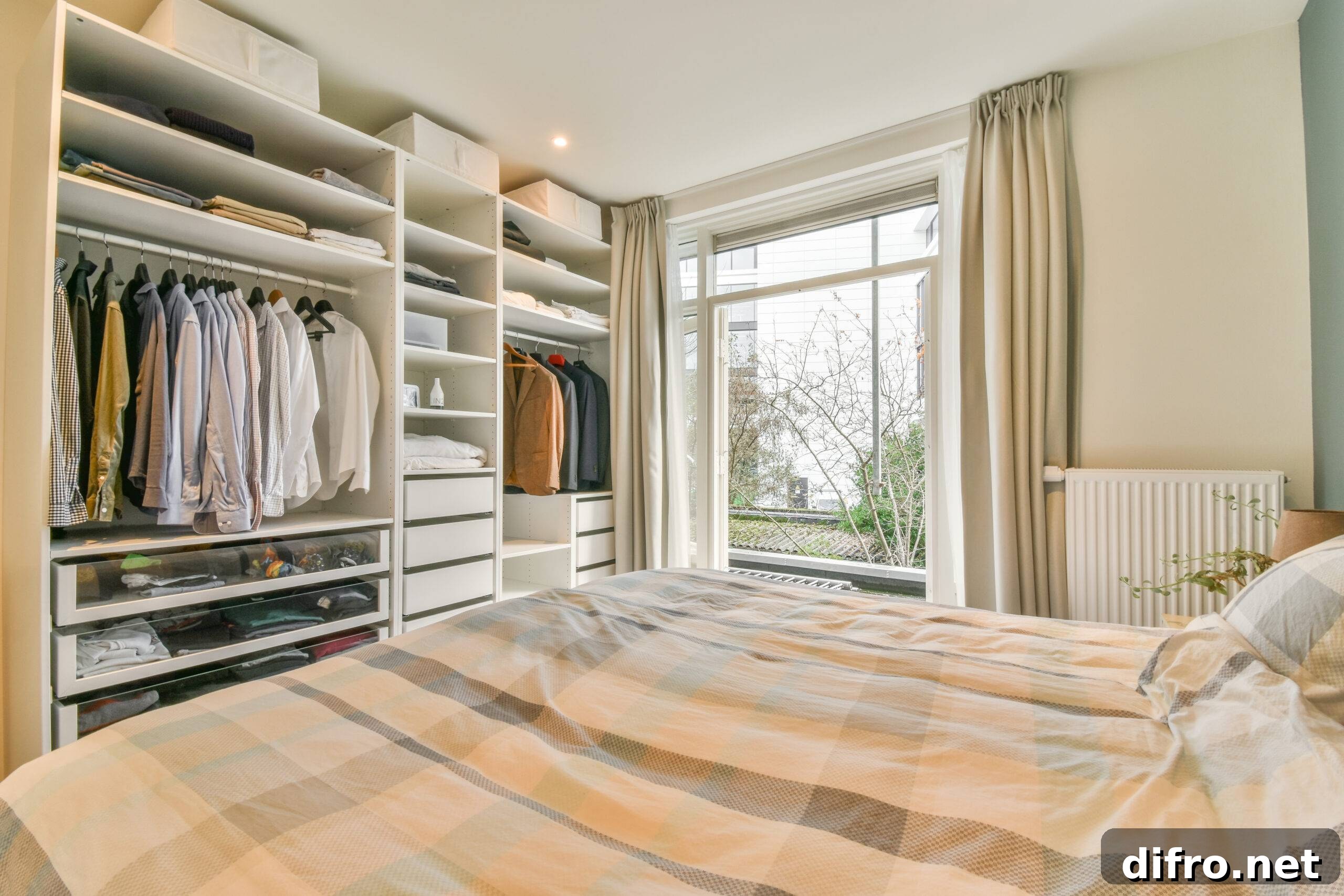 A built-in wall closet unit across from a bed.