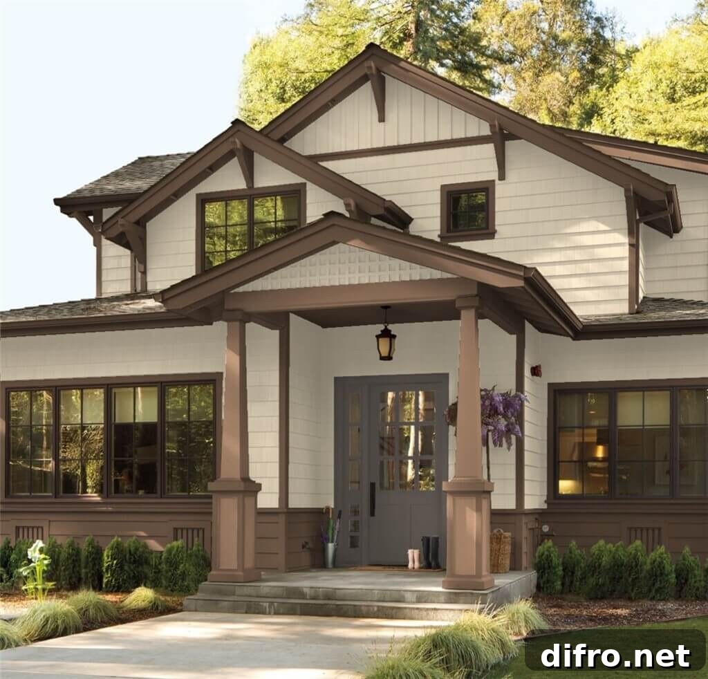 A family home with off-white siding and brown trim.