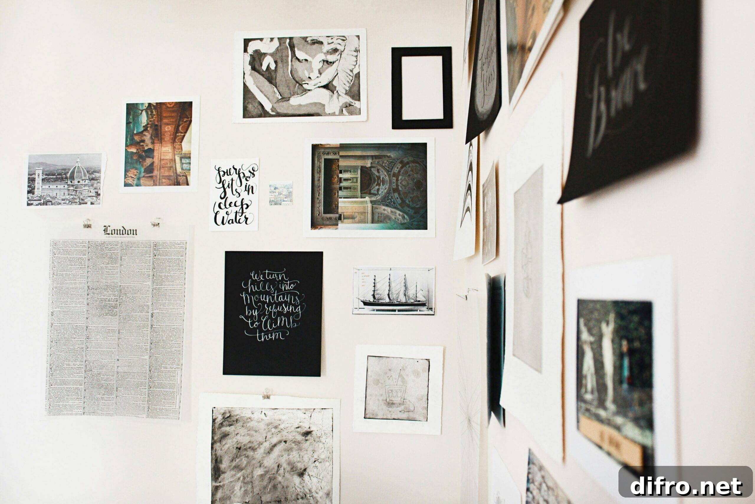 The corner of two walls both covered in unframed art.