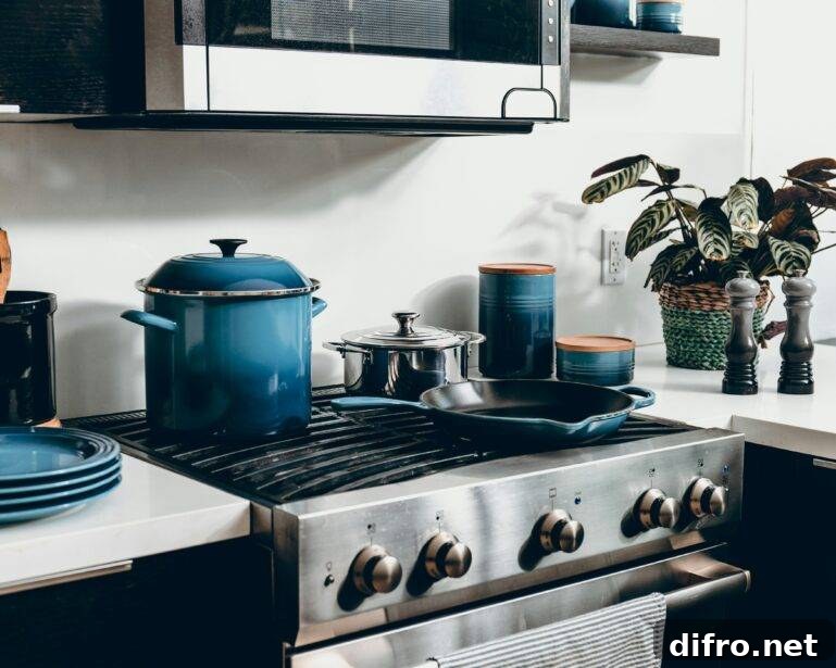 A set of blue cookingware on a stove range.