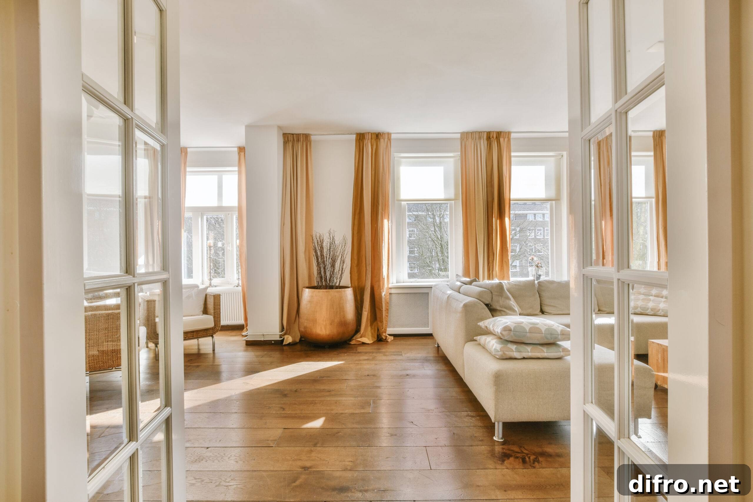 Warm Minimalism: How Cozy Design Transforms Minimalist Interiors 6 Stylish home interior design of spacious living room with large windows and white walls furnished with comfy couch and table on carpet on parquet floor