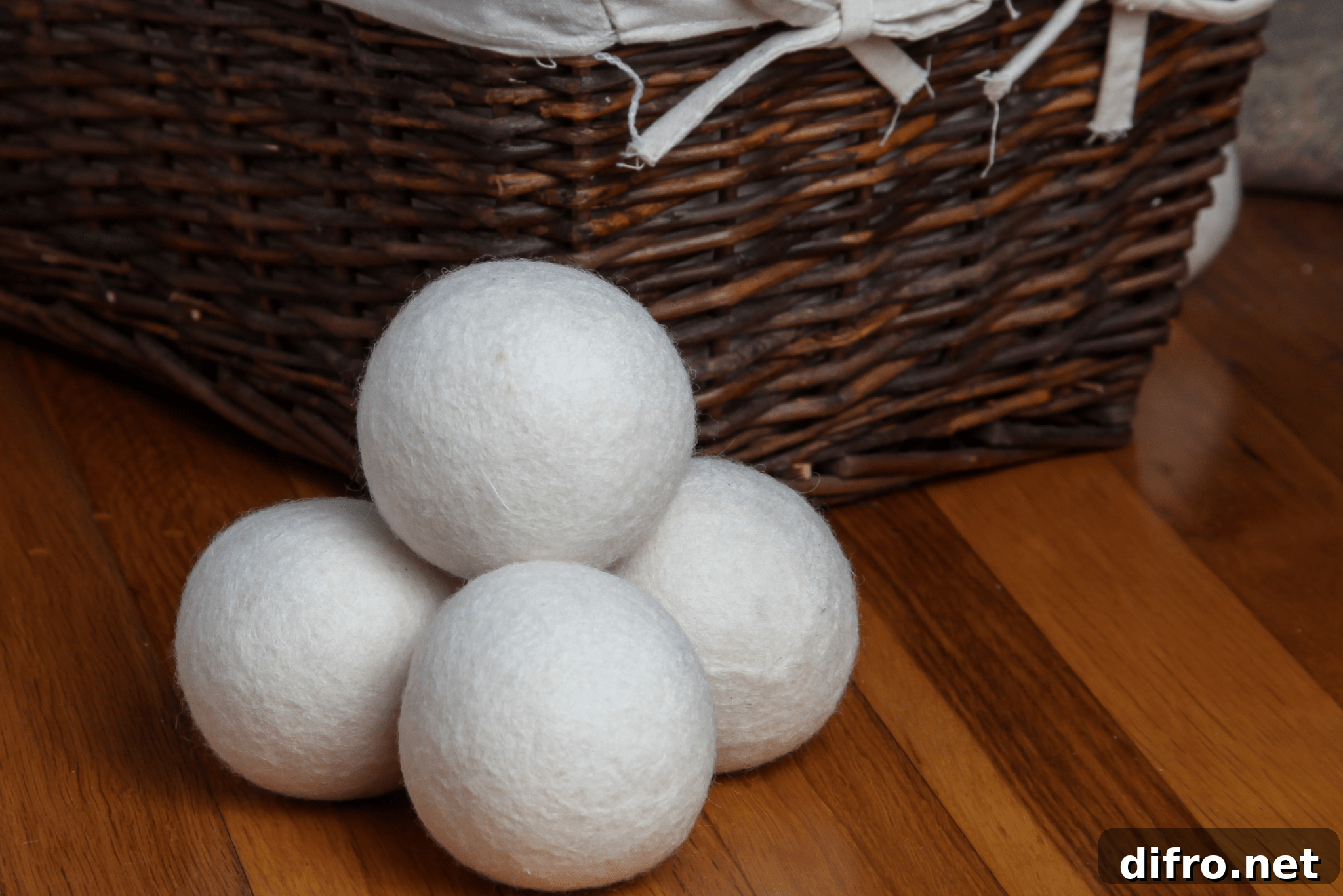 Do Tennis Balls Work as Dryer Balls? Pros and Tips for Laundry 6 A stack of dryer balls next to a laundry hamper.