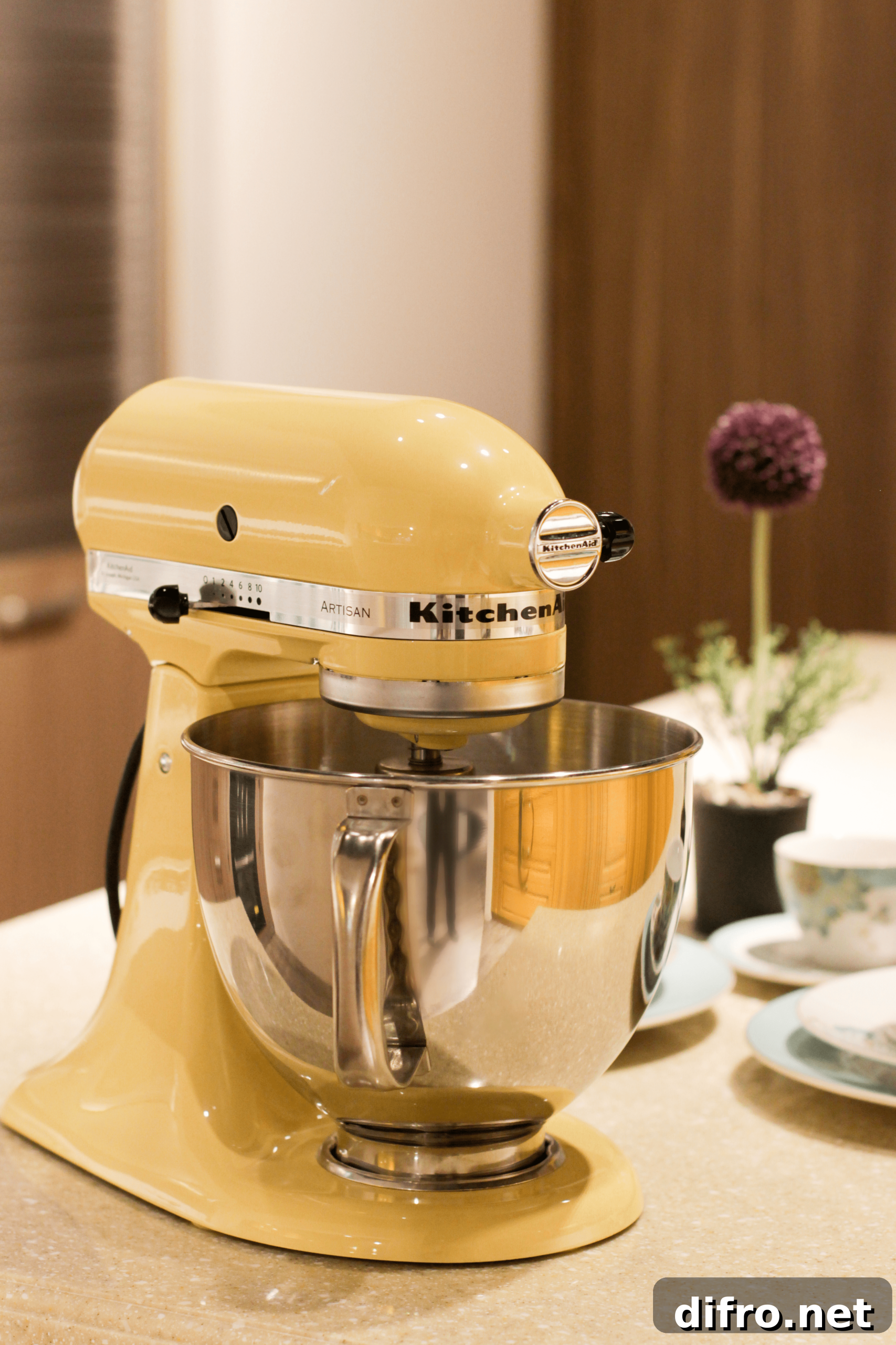 A yellow kitchenaid mixer on a countertop.