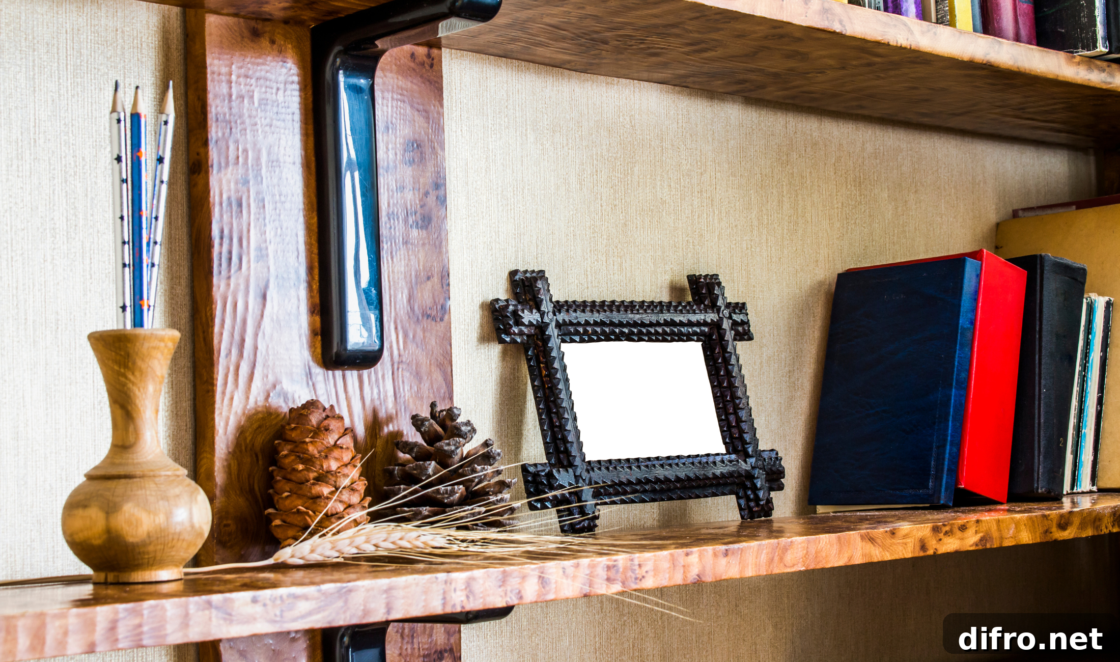 A bookshelf with a small picture frame on it next to a row of books.