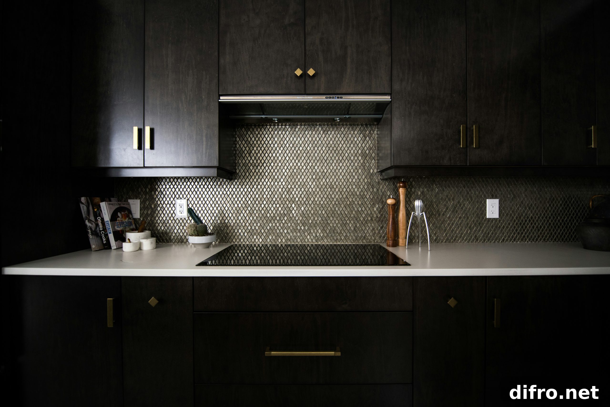 A kitchen with black cabinets and modern hardware.