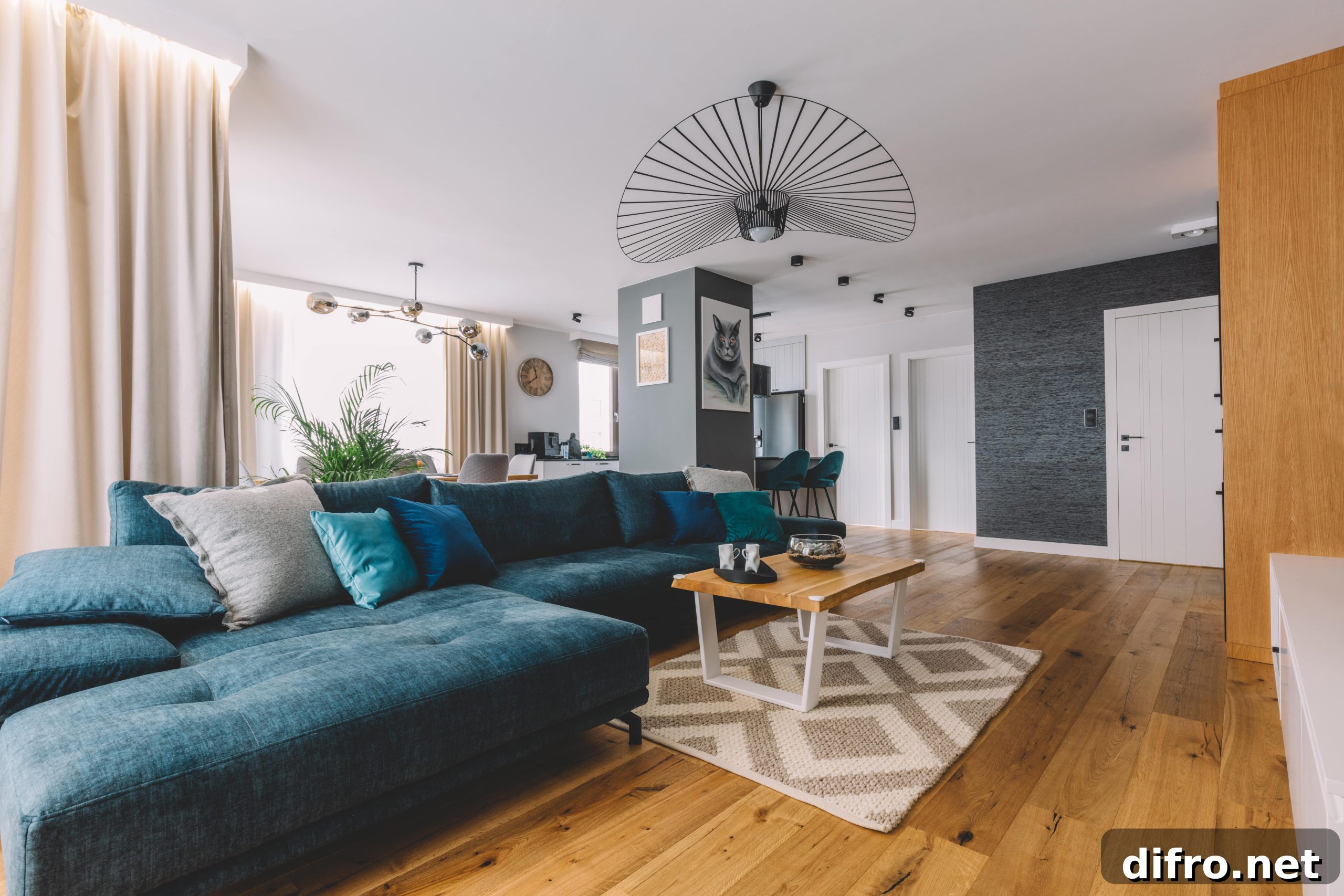 An open living room with a large, L-shaped blue couch.