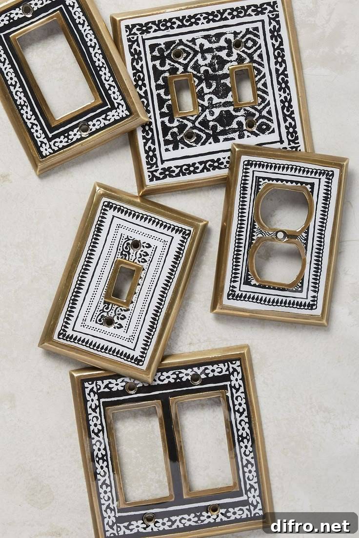 An assortment of brass light switch covers with black and white patterns painted on it.