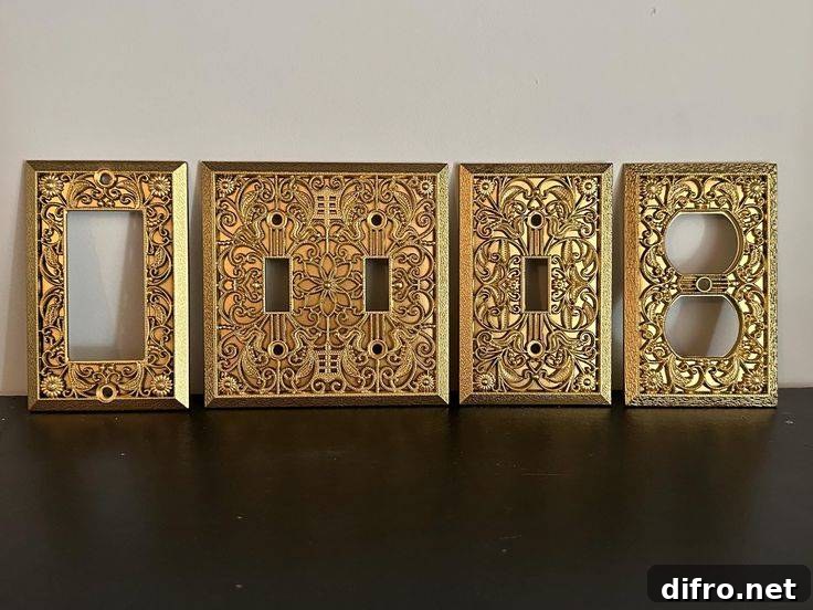 An assortment of gold light switch covers with intricate embossed patterns.