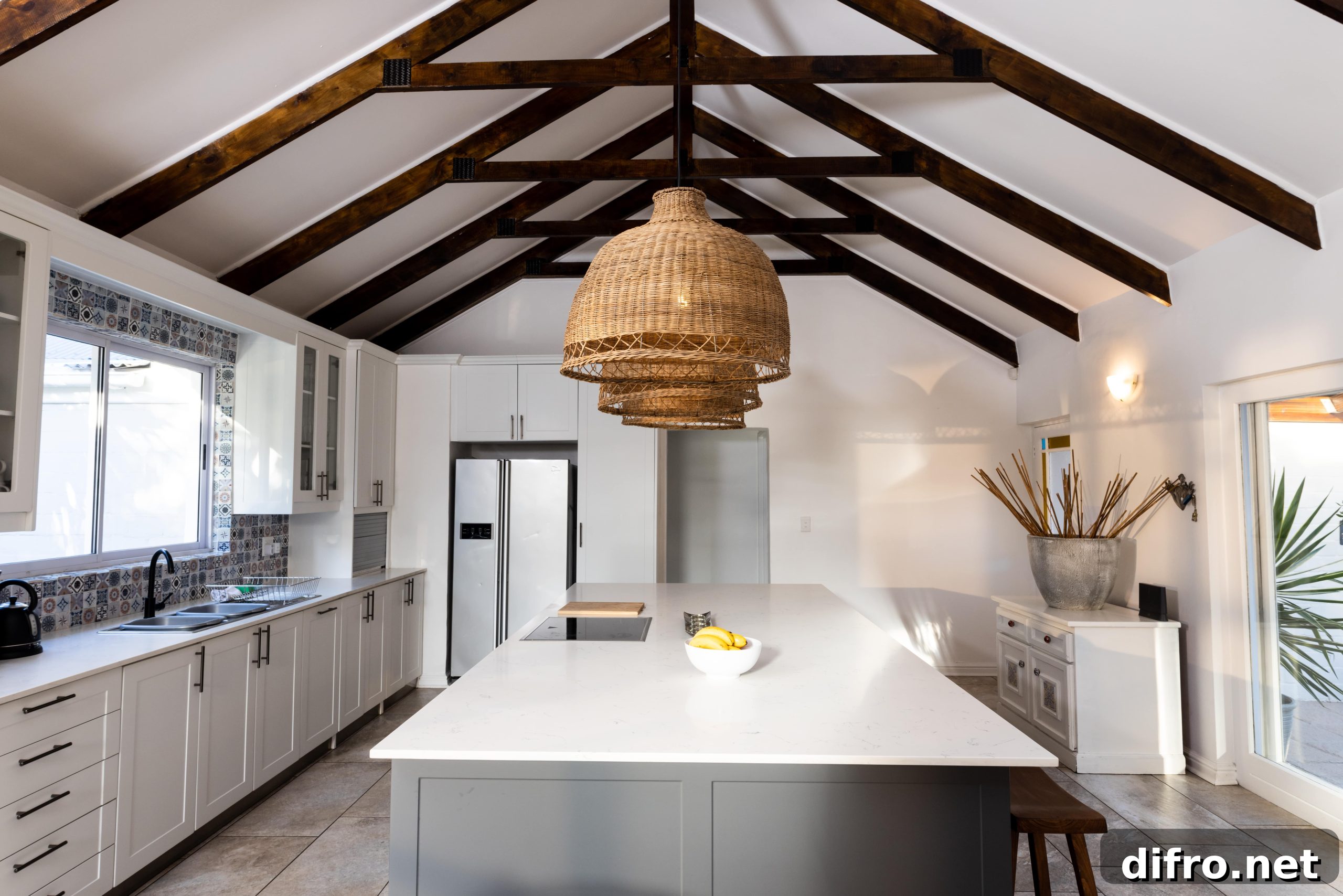 One Upgrade to Make Your Kitchen Look More Expensive 5 A large modern kitchen with visible ceiling strats.