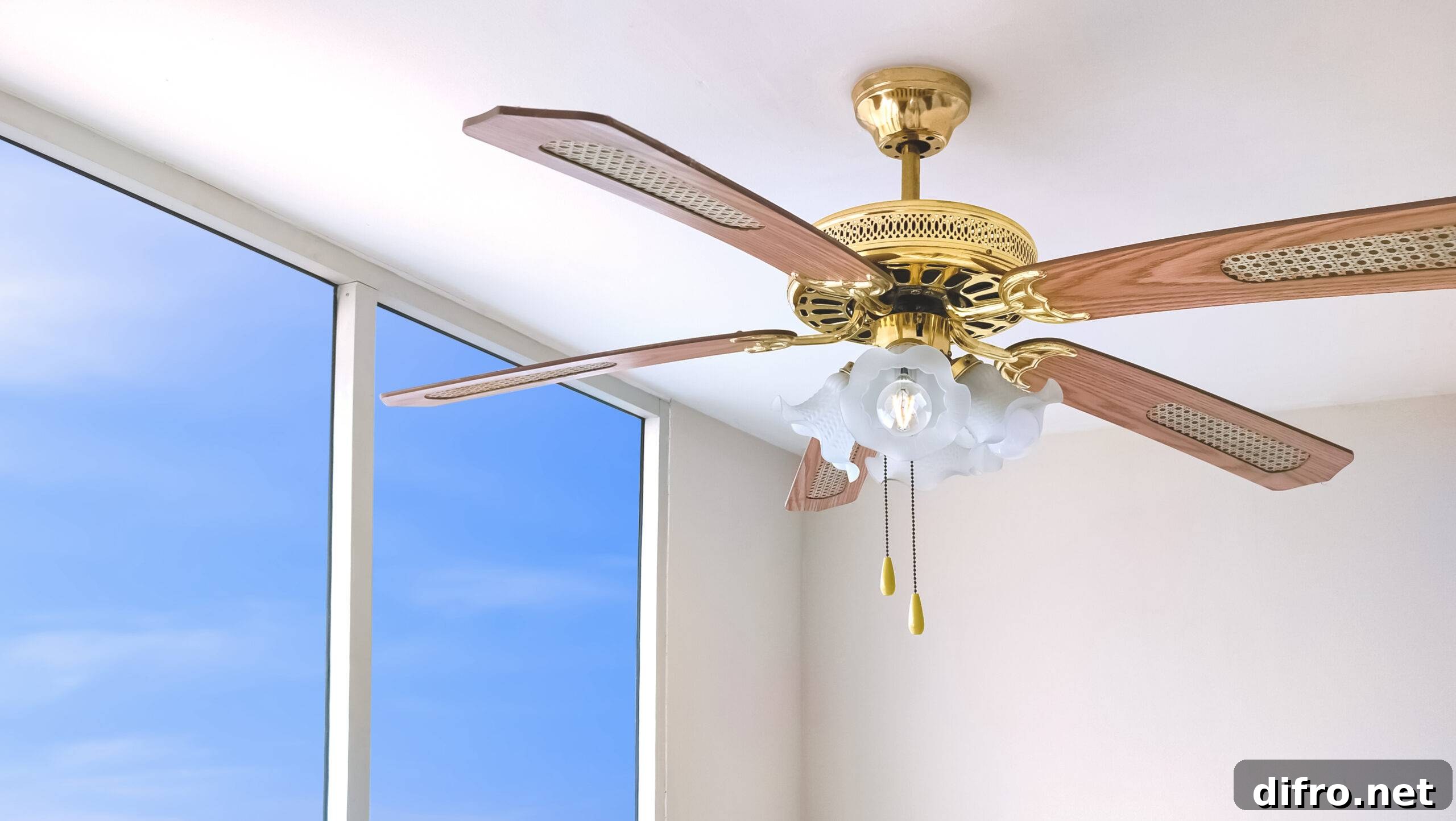 A ceiling fan next to large, sunny balcony doors.