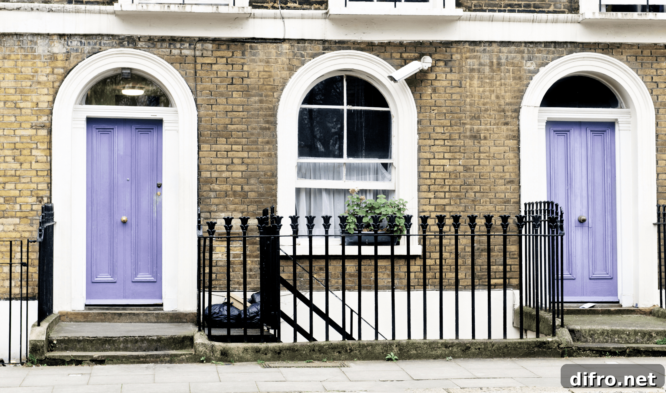 Two joined homes with light purple front doors.
