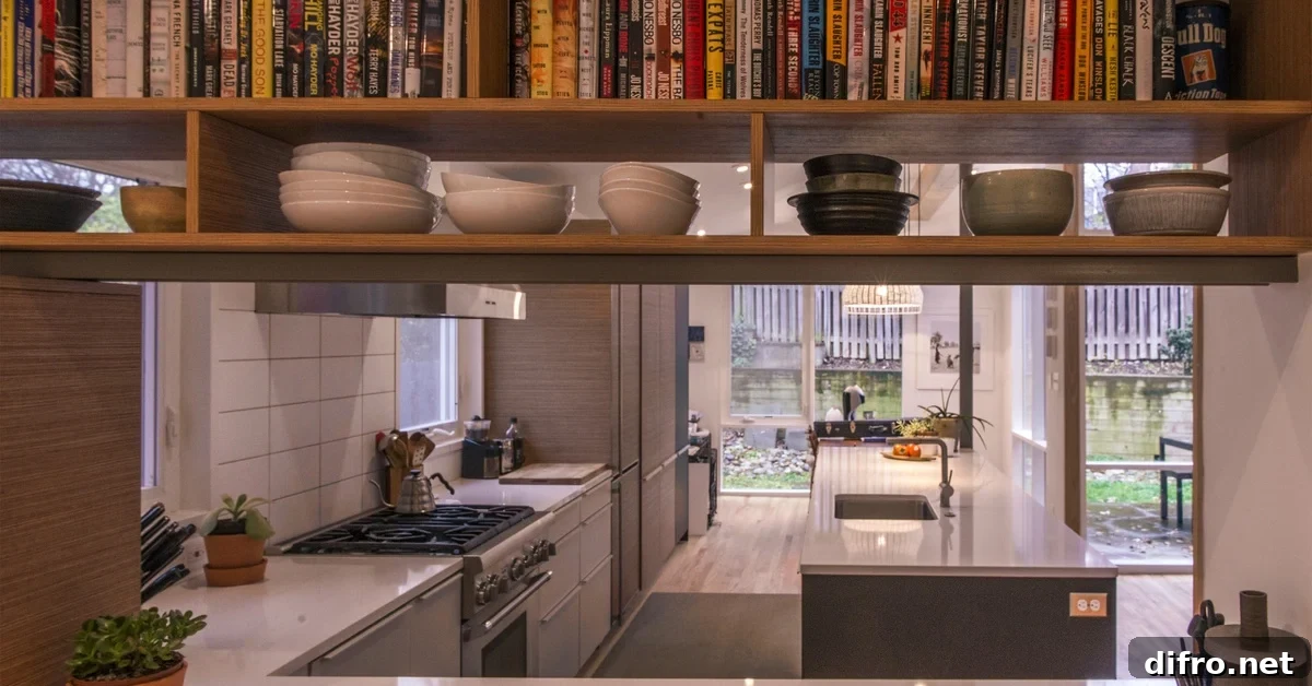 A view through the new entryway using books and display shelves into the kitchen of Gabriela Sakamota and Tim Vermeulen's remodeled mid century house on November, 19, 2015 in Takoma Park, MD.