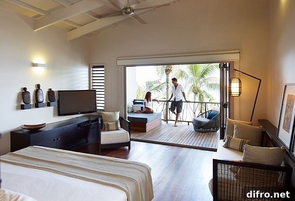 Large white bedroom with beach views balcony