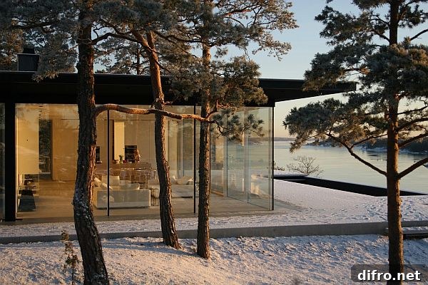 Open-plan interior with expansive windows facing the lake