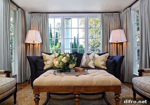 Black couch and grey drapes with floor lamps