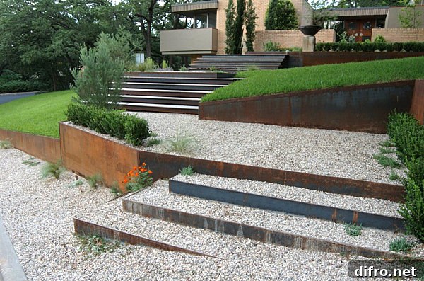 A xeriscaped garden path with orange flowers