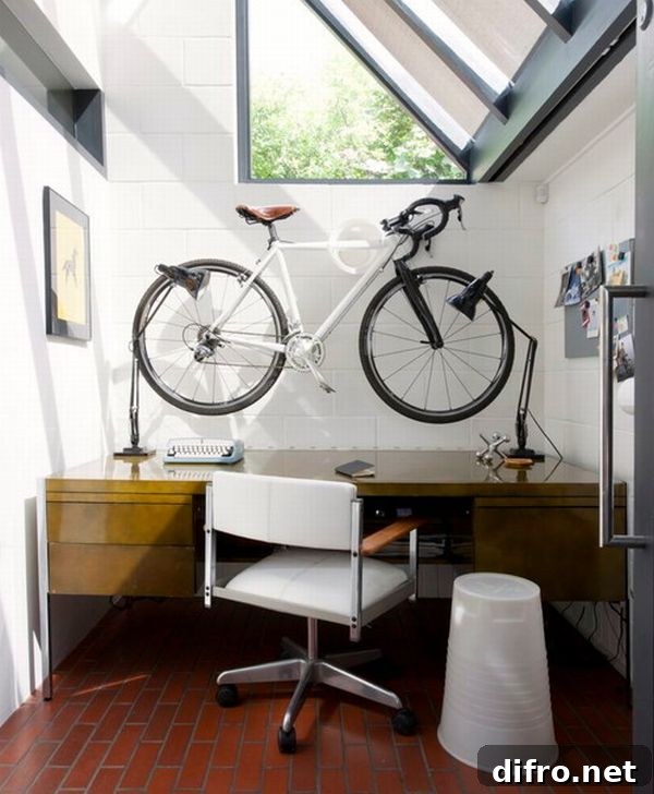 Space conscious home office with sloped windows and a bicycle mounted on the wall