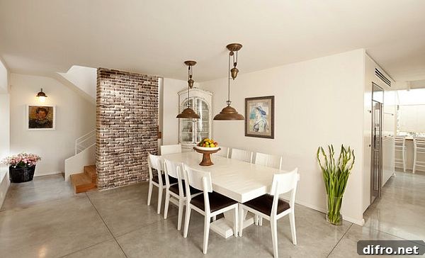 Exposed brick accent wall in dining room