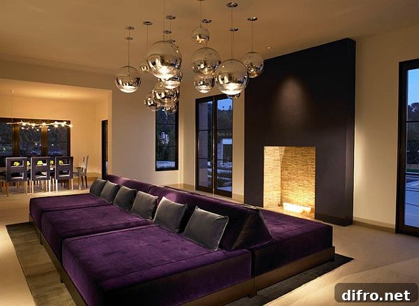 Stylish rec room with purple double couch and a fireplace
