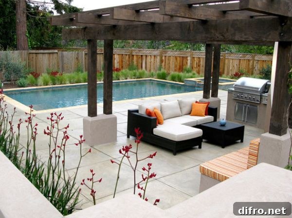 White cushions and deck space offer a lovely contrast to the dark wood of the pergola