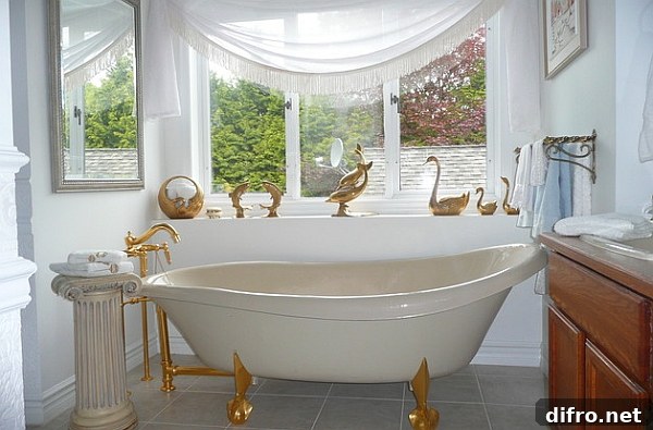 French flair and golden accents define this lavish bath space