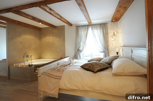 Urban bedroom bathtub with stone tiles and floral accents