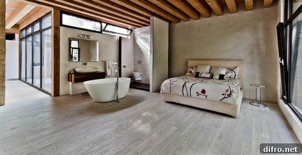 Bedroom bathtub with stone floor and towel rack