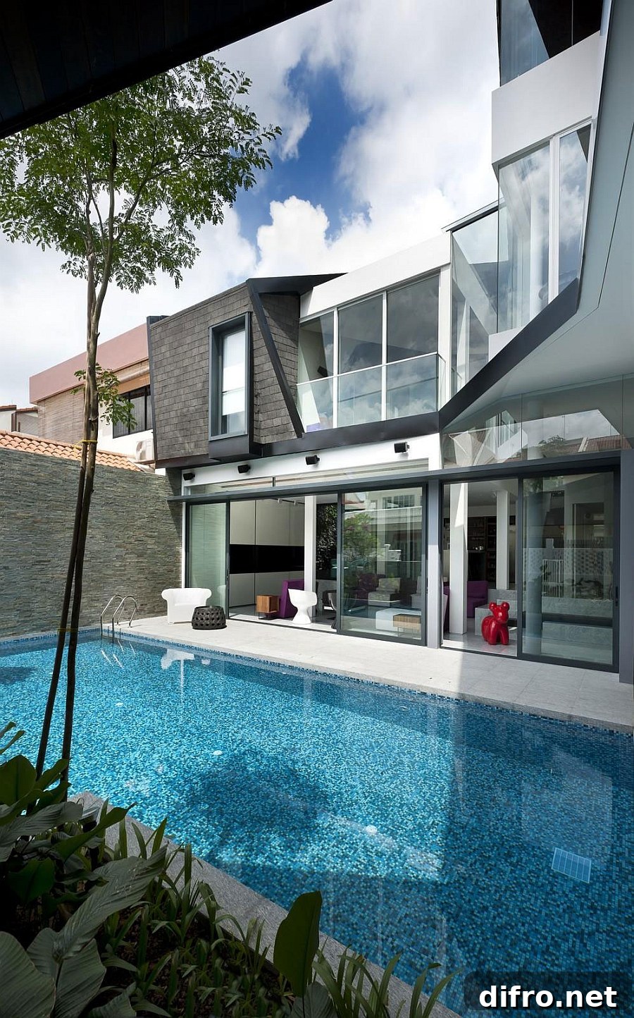 Refreshing swimming pool connected visually with the indoors